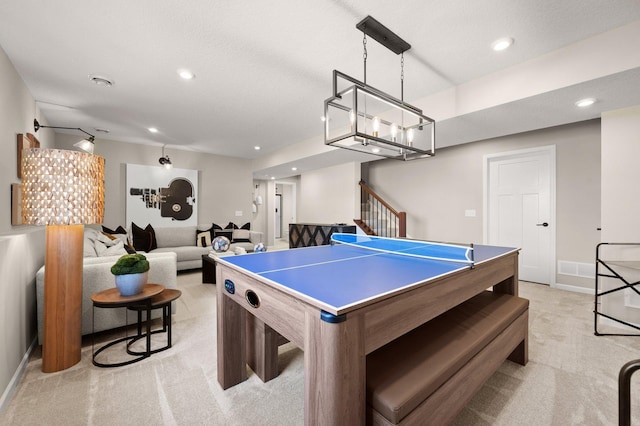 playroom with light colored carpet and a textured ceiling