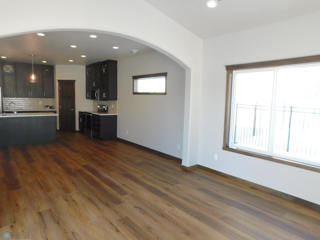 unfurnished living room with dark hardwood / wood-style flooring and sink