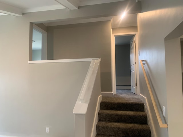 staircase featuring a baseboard heating unit, carpet flooring, and beam ceiling