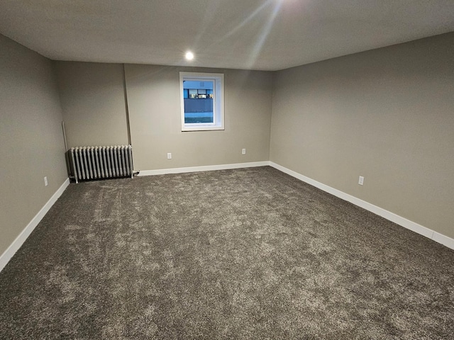 interior space with carpet and radiator heating unit