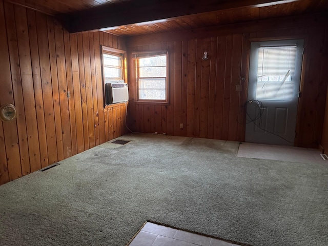 entrance foyer with light carpet, wooden walls, and beamed ceiling