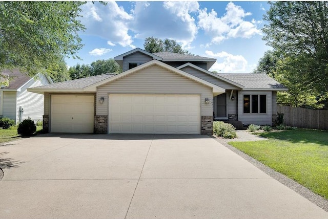 view of front of home with a garage and a front yard