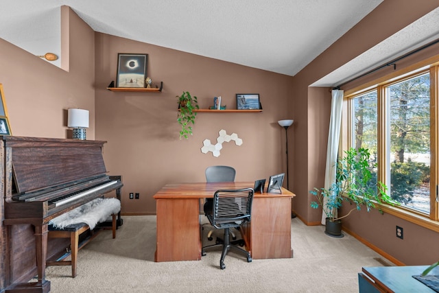 office with lofted ceiling and light carpet