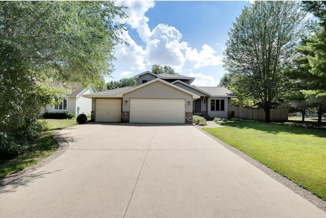 view of front of house with a garage and a front yard