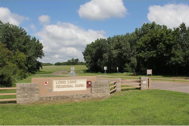 community / neighborhood sign with a lawn