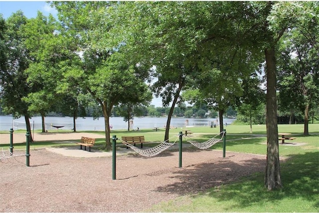 view of community with a water view and a lawn