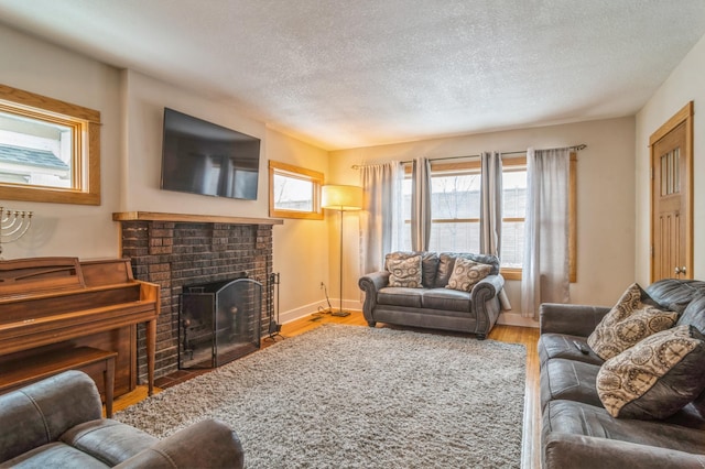 living room with hardwood / wood-style floors, a textured ceiling, and a fireplace