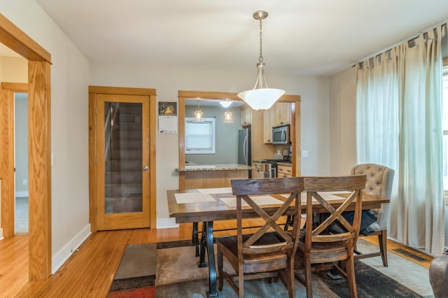 dining area featuring light wood-type flooring