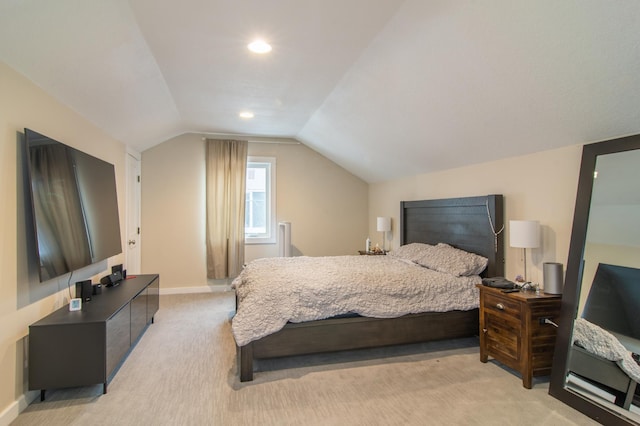 bedroom featuring light carpet and vaulted ceiling