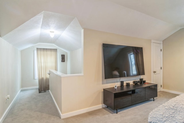 carpeted living room featuring lofted ceiling and a textured ceiling