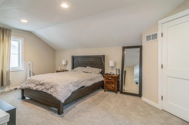 carpeted bedroom with vaulted ceiling