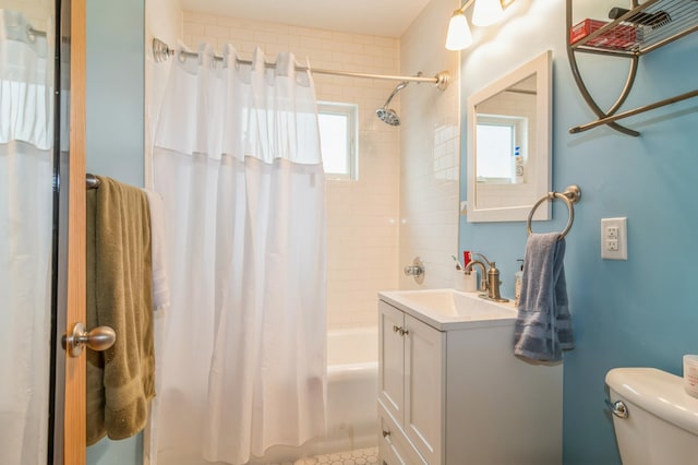 full bathroom with vanity, toilet, shower / bath combo, and a wealth of natural light