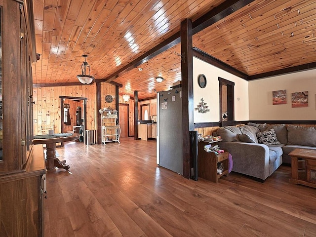 living room featuring vaulted ceiling, wood walls, wood ceiling, and wood finished floors