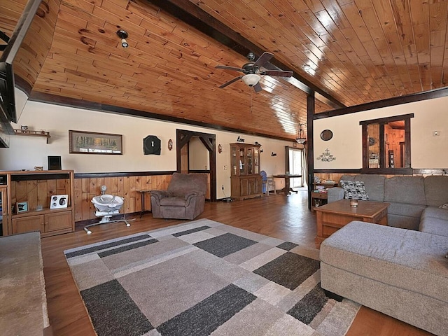 living area with wainscoting, wood ceiling, a ceiling fan, and wood finished floors