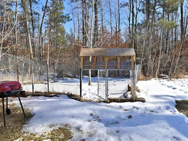 yard covered in snow with fence