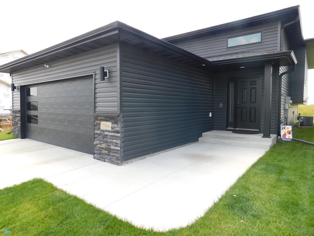 view of front facade with cooling unit, stone siding, and a garage