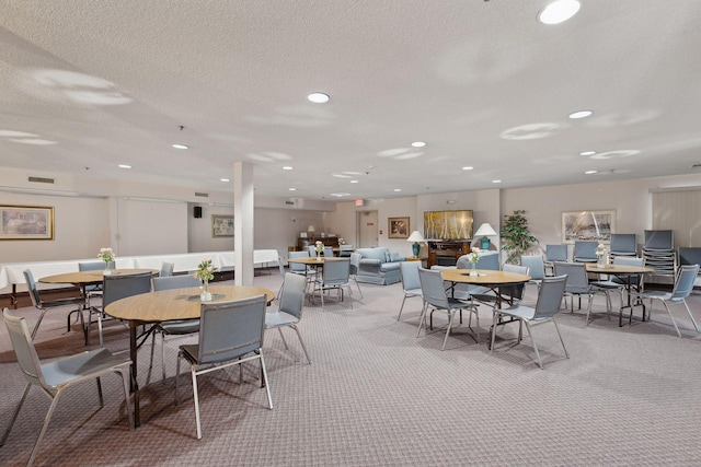 dining space featuring carpet floors, a textured ceiling, visible vents, and recessed lighting