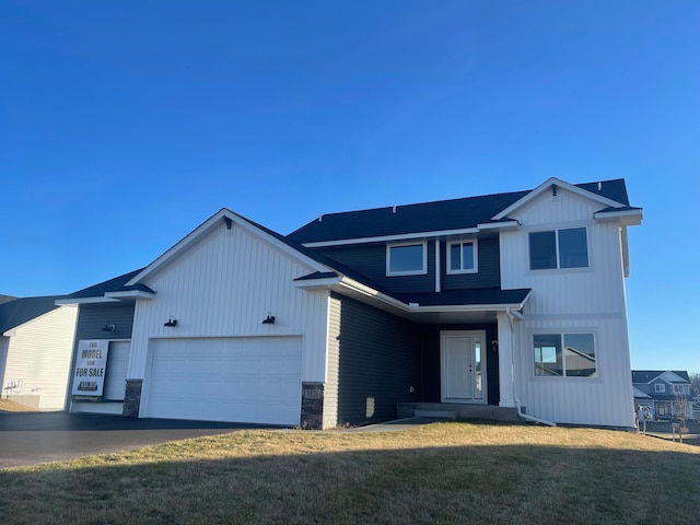 view of front of home with a garage and a front yard