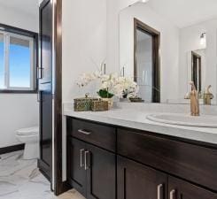 bathroom with toilet and vanity