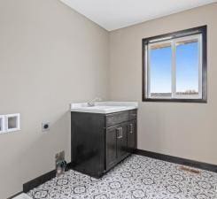 laundry area featuring sink and hookup for an electric dryer