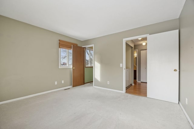 unfurnished bedroom with light colored carpet