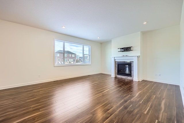 unfurnished living room featuring dark hardwood / wood-style flooring