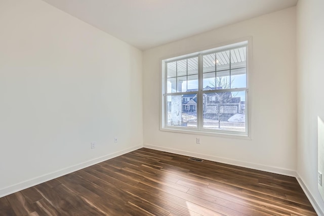 spare room with dark wood-type flooring