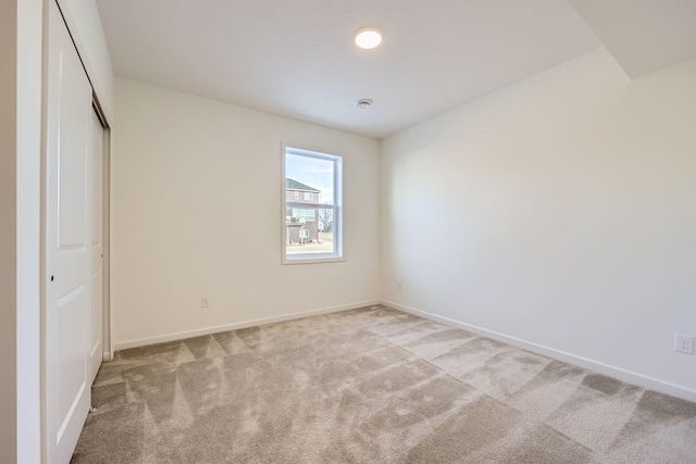 unfurnished bedroom with a closet and light carpet