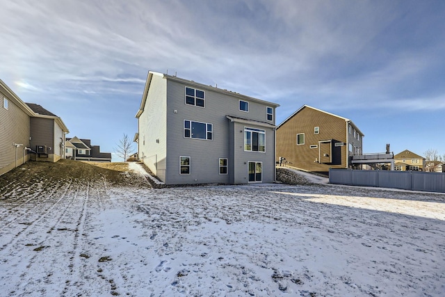 view of snow covered rear of property