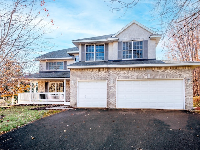 view of front facade with a garage and a porch