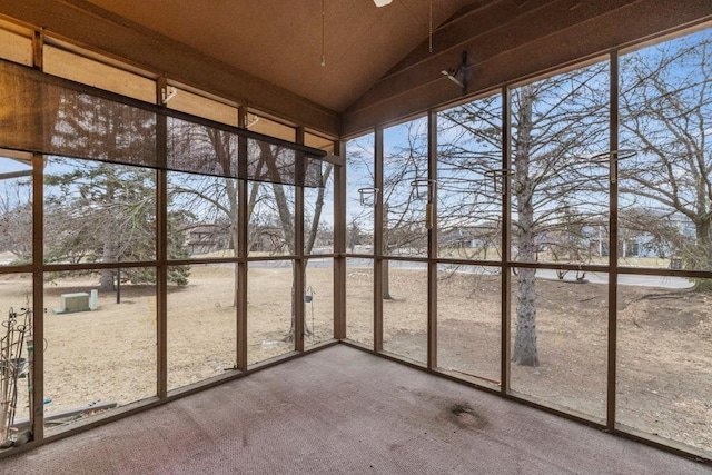 unfurnished sunroom featuring vaulted ceiling