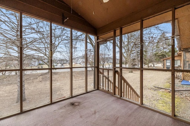 unfurnished sunroom with lofted ceiling and a wealth of natural light