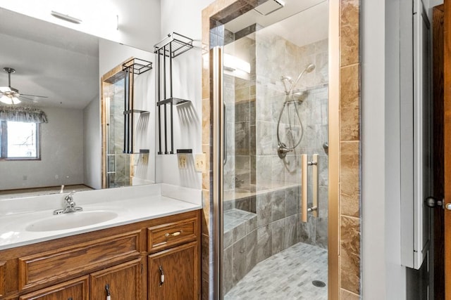 bathroom featuring vanity, ceiling fan, and walk in shower