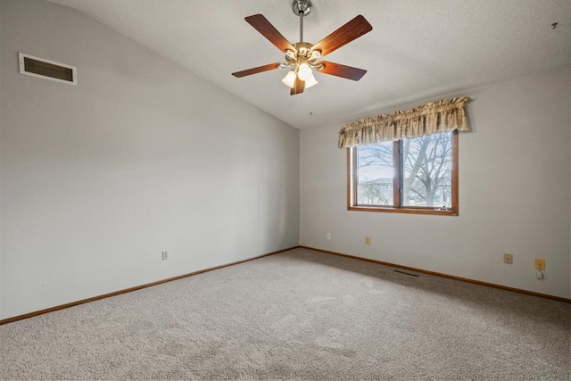 unfurnished room featuring vaulted ceiling, ceiling fan, and carpet flooring