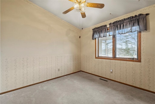 carpeted empty room featuring ceiling fan