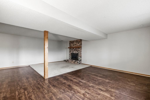 unfurnished living room with hardwood / wood-style flooring and a brick fireplace