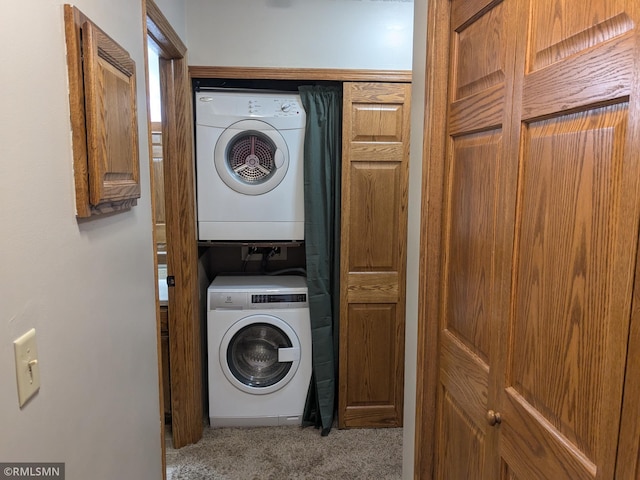 laundry area featuring stacked washer / dryer