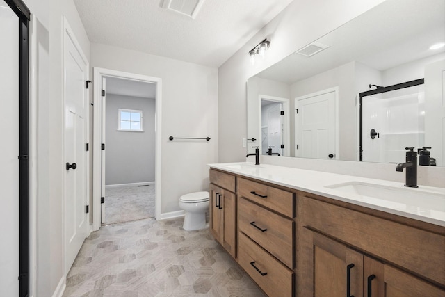 bathroom featuring vanity, a textured ceiling, a shower, and toilet