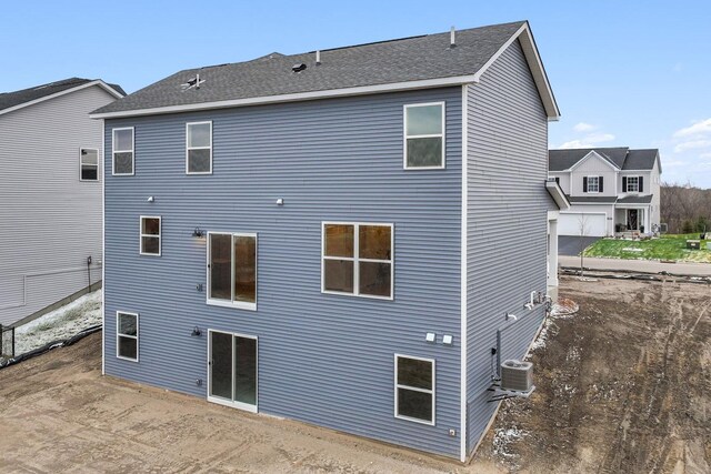 rear view of property featuring central AC