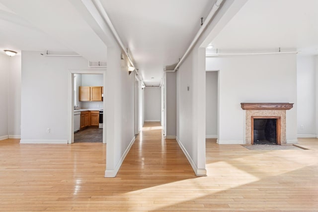 hallway with light hardwood / wood-style flooring