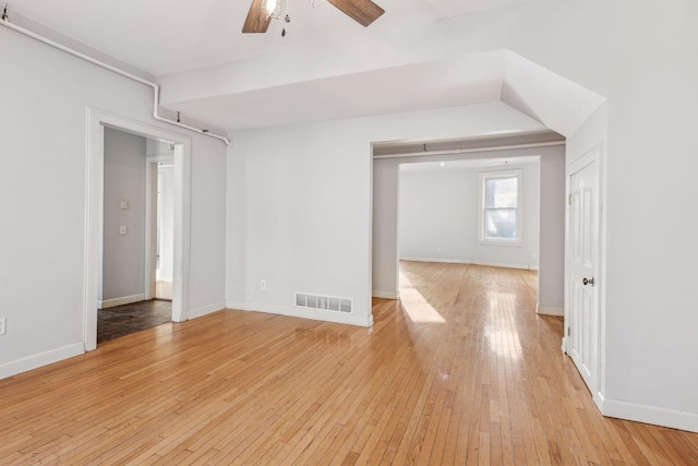 empty room featuring ceiling fan and light hardwood / wood-style flooring