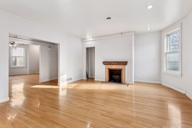 unfurnished living room featuring light wood-type flooring and ceiling fan