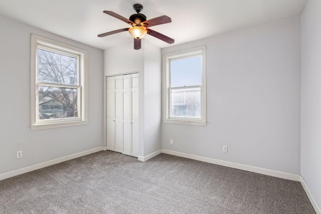 unfurnished bedroom featuring ceiling fan, a closet, and carpet floors