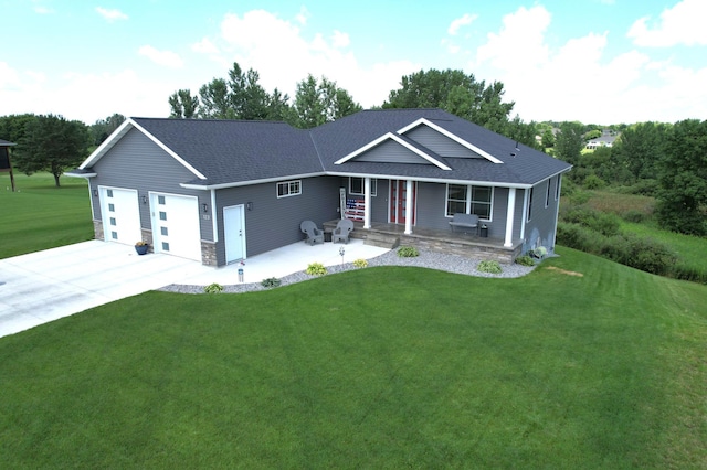 view of front of property featuring a garage, covered porch, and a front lawn