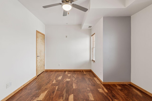 empty room featuring ceiling fan and dark hardwood / wood-style flooring