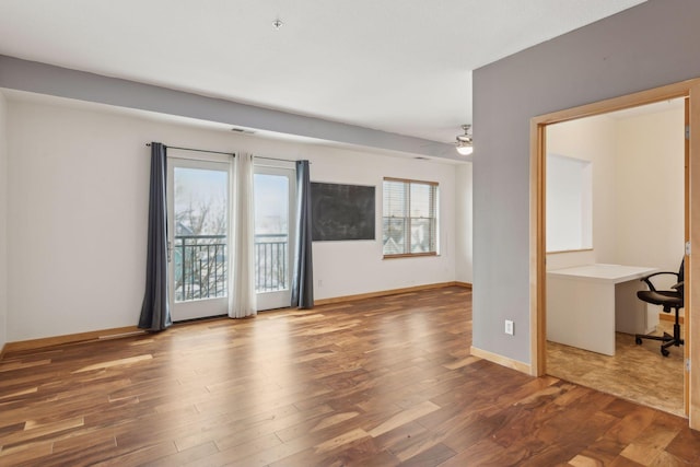 unfurnished room with wood-type flooring and ceiling fan