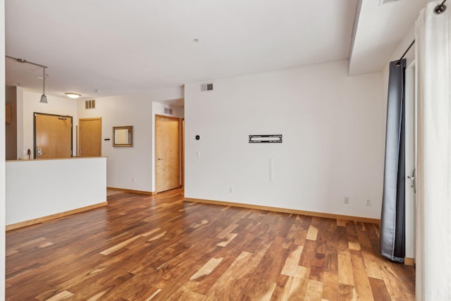 unfurnished room with hardwood / wood-style floors and sink