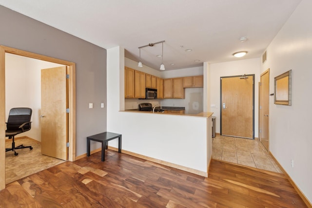 kitchen with hardwood / wood-style floors, kitchen peninsula, and stainless steel electric range oven