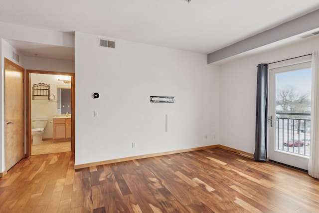 empty room with sink and light wood-type flooring