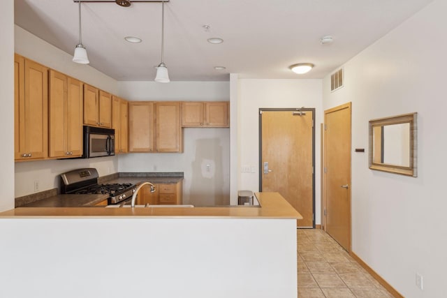 kitchen featuring appliances with stainless steel finishes, decorative light fixtures, sink, light tile patterned floors, and kitchen peninsula